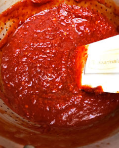 To strain red chile sauce, pour into a colander and, using a rubber spatula, work in circles to separate sauce from remaining particles. | mjskitchen.com