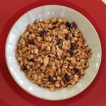 Bowl of granola with walnuts, raisins and coconut