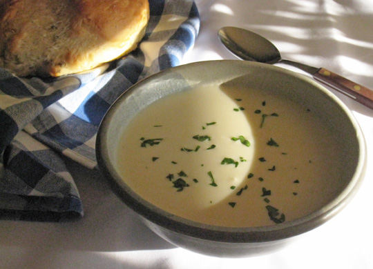 Bowl of Garlic soup with a garnish of parsey