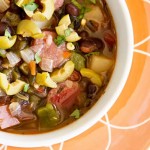 Soup with andouille, black beans, chile, tomatoes, pototes and olives