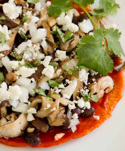 Enchiladas with black beans, shiitakes, feta, and red chile sauce
