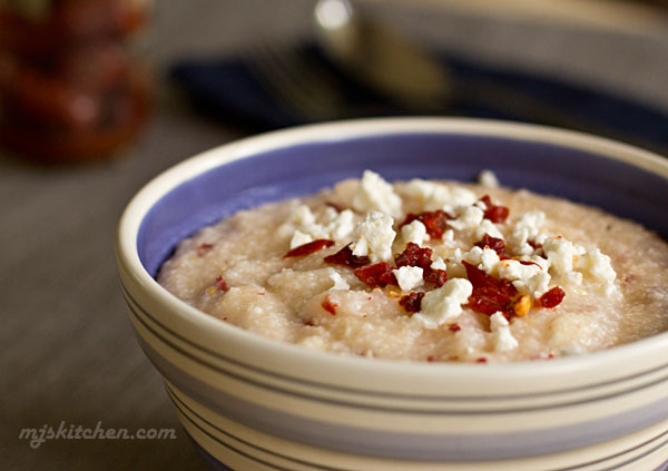 A bowl of southern grits with chipotle peppers and feta cheese