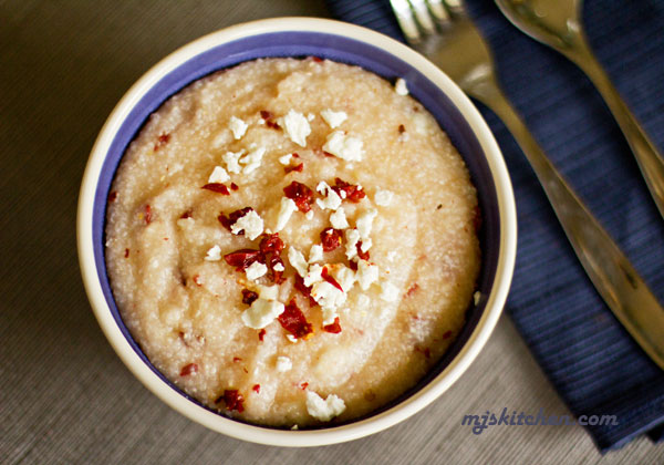 A bowl of grits with chipotle peppers and feta cheese