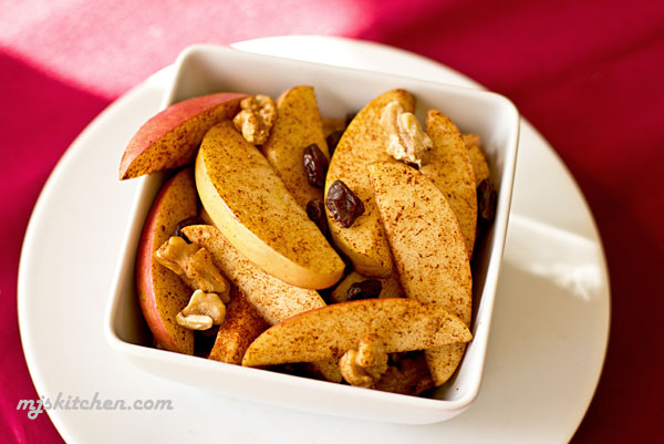 An easy snack made with apples, walnuts, raisins and cinnamon