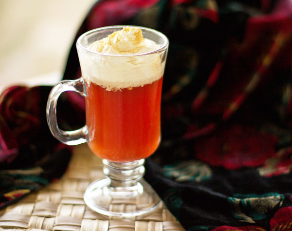 Rooibos chai brewed in cranberry juice, topping with whipped cream and ginger mjskitchen.com