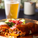 A vegetarian burrito with pinto beans and seared peppers and onions, smothered in New Mexico red chile sauce | mjskitchen.com