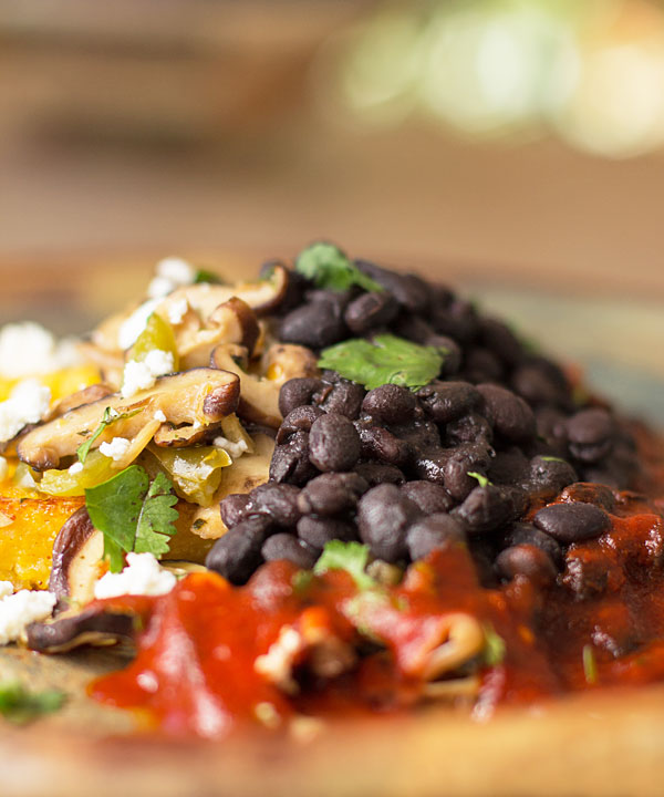 A hearty vegetarian meal with shiitake, black beans, fried polenta and feta smothered in New Mexico red chile @redchile #shiitake #blackbean #vegetarian @mjskitchen