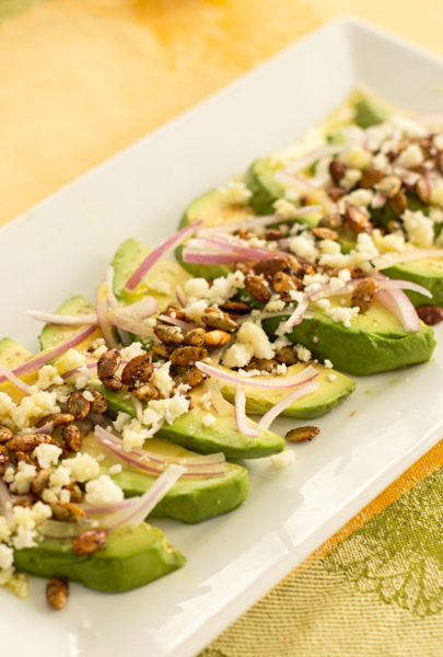 Avocado Onion Salad with pepitas, cotija cheese and a lime garlic dressing. Serve as a starter or salad. #avocado #appetizer #pepitas @mjskitchen