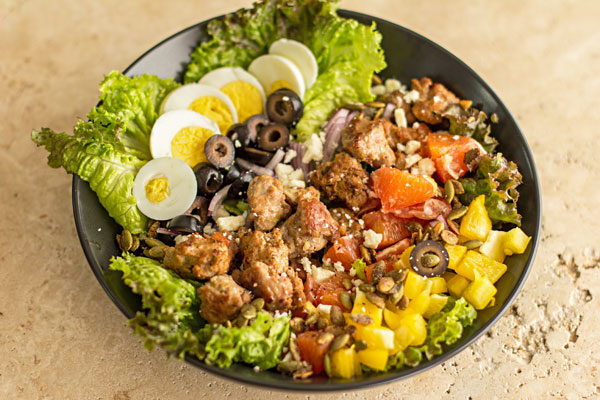 A composed salad with Hatch Chill Sausage and a variety of healthy salad ingredients. | mjskitchen.com