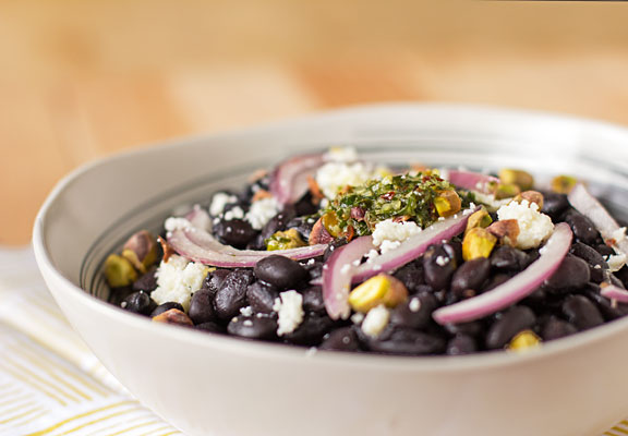 A mouthwatering bowl of black beans, chimichurri, and pickled onion with cotija cheese and pistachios. #blackbeans #chimichurri @mjskitchen