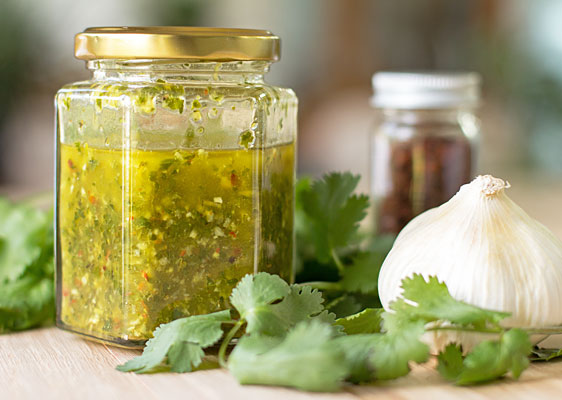 A chimichurri sauce that uses a combination of parsley and cilantro, and lots of garlic (a standard ingredient for chimichurri) #chimichurri #pebres #cilantro #parsley | mjskitchen.com