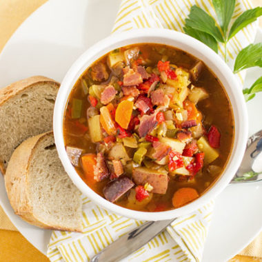 A hearty and healthy garden vegetable soup made with garden vegetables and topped with a little bacon. #soup #redchile #vegetable @mjskitchen