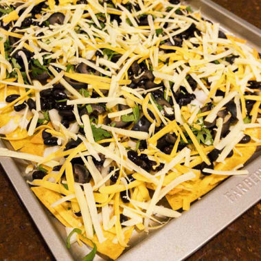 Vegetarian nachos with black beans, olives, cilantro, cheese and pica de gallo. #nachos #vegetarian @mjskitchen