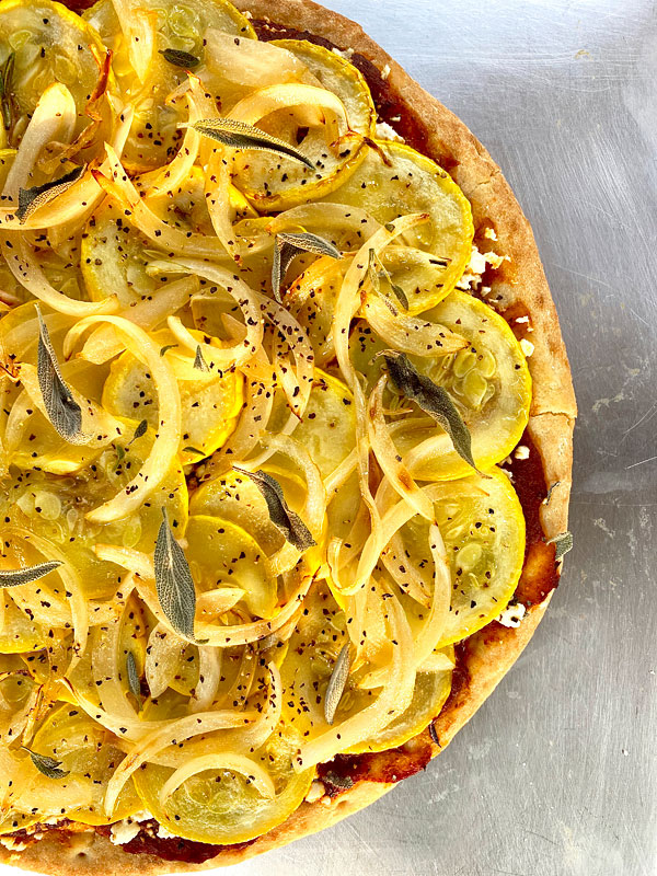 A grilled yellow squash pizza with pizza sauce, feta, and sage #squash #yellow #pizza @mjskitchen