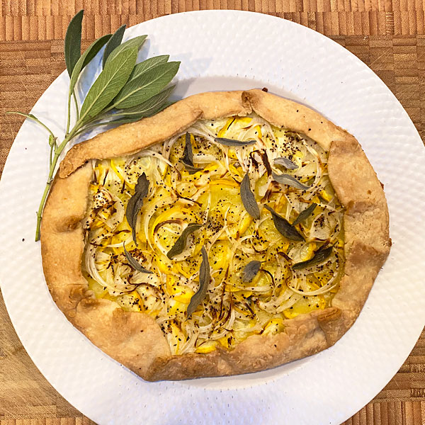 A delicious galette with yellow squash, onion, sage and feta cheese #galette #squash #sage @mjskitchen