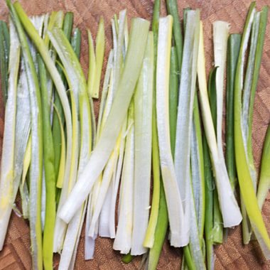Prep scallions for kimchi by cutting them in half lengthwise @mjskitchen