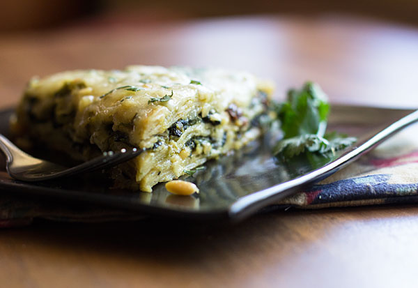 Spinach Enchiladas with a filling of spinach, raisins and piñon, smothered in a green chille cheese sauce. #enchiladas #greenchile #vegetarian