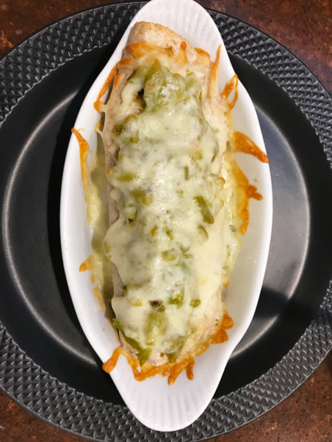 A scrumptious burrito stuffed with green and chicken and smothered with green chile and cheese. #burrito #greenchile #hatchchile @mjskitchen