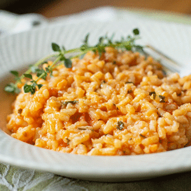 A creamy and scrumptious risotto cooked with confit tomatoes (slow-roasted in to olive oi) and lots of fresh herbs. Our favorite risotto! #rice #risotto #tomato #freshherbs @mjskitchen