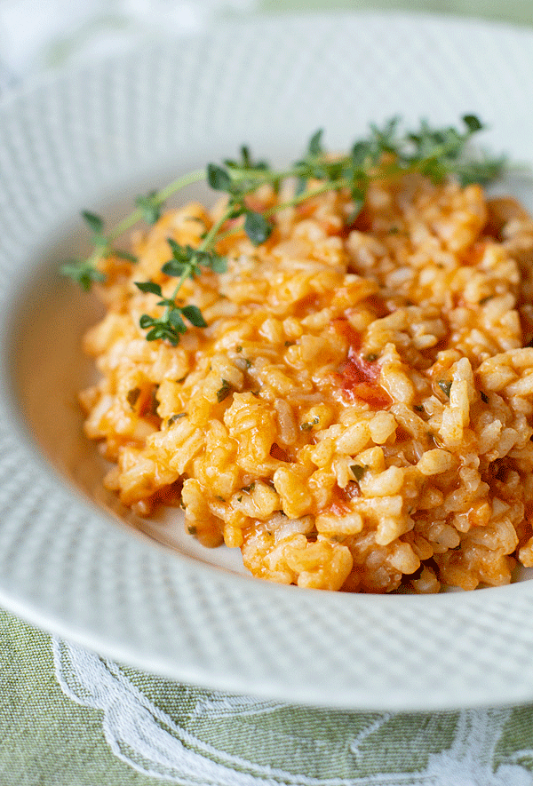 A creamy and scrumptious risotto cooked with confit tomatoes (slow-roasted in to olive oi) and lots of fresh herbs. Our favorite risotto! #rice #risotto #tomato #freshherbs @mjskitchen